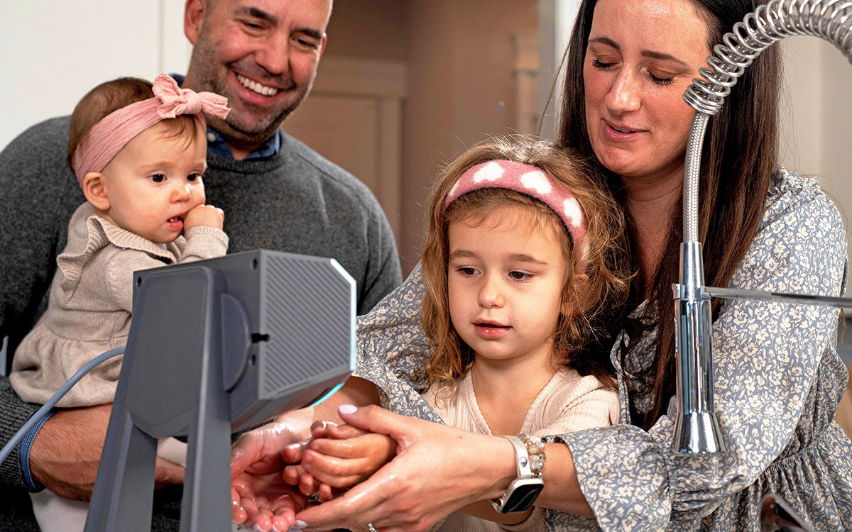 family drying their hands in the kitchen of their home