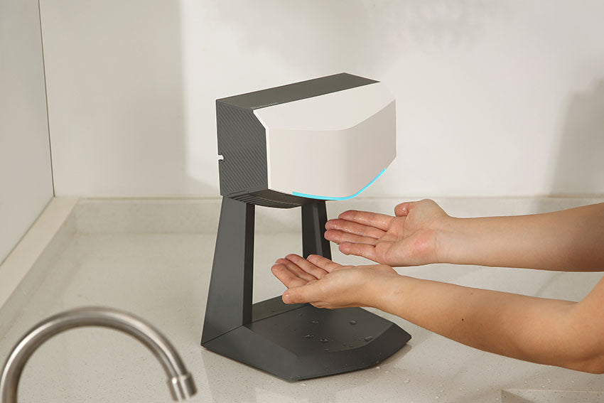 person drying their hands in the kitchen using the revsquared hand dryer